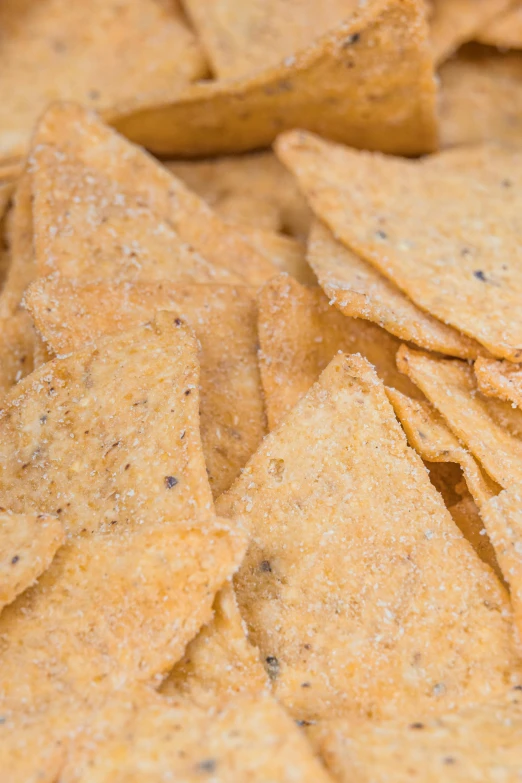 many tortilla chips are stacked on top of each other