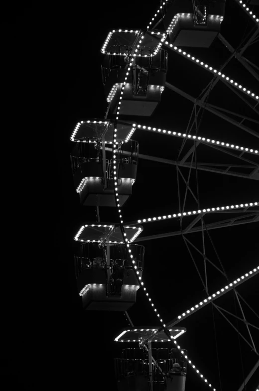 a ferris wheel with lights lit up at night