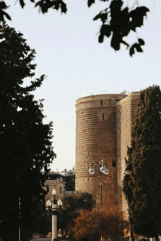 large round clock tower near small trees