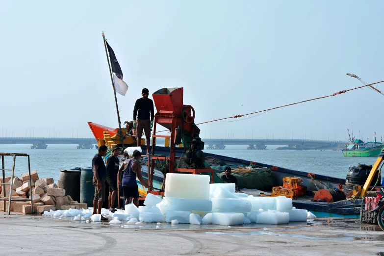 two men prepare to work on a boat at a dock