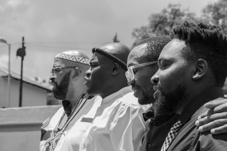 a group of men standing together outside