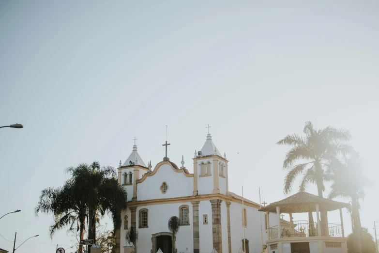 a church with trees and bushes in front