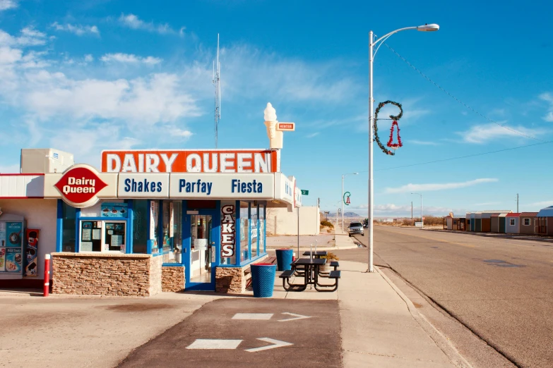 the small store called dairy queen is located on the side of the street