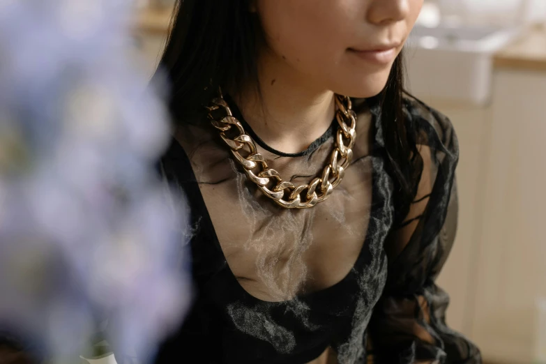 a close up image of a woman wearing large necklaces