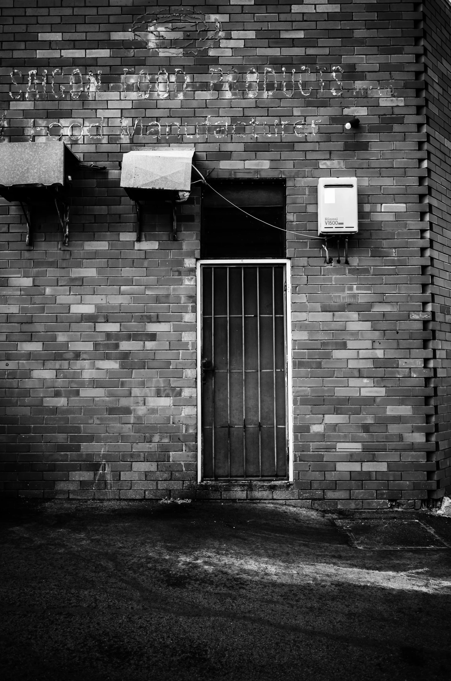 an old black and white po of a brick wall with a doorway