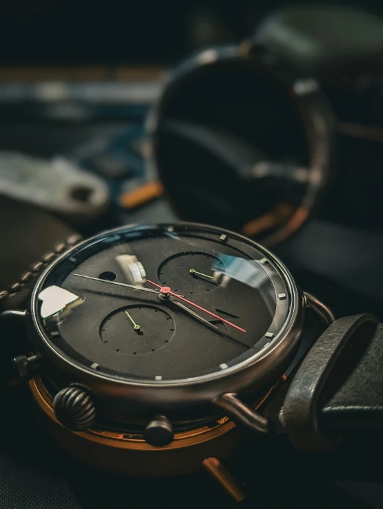 an old black wrist watch laying on the seat of someones car