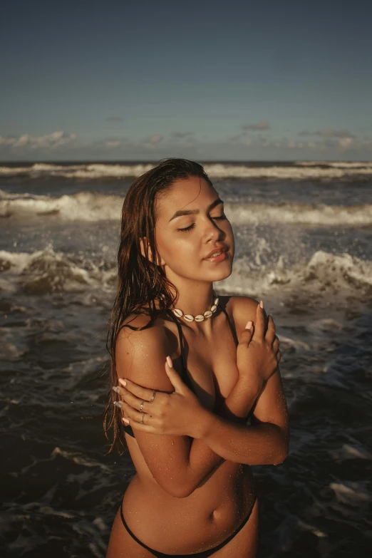 a  woman standing in the ocean near the shore