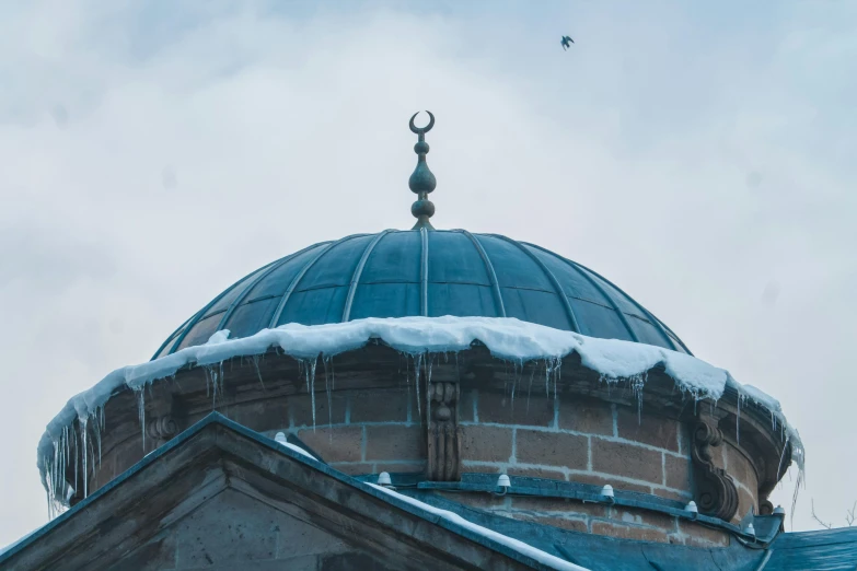 a clock tower has icicles hanging on it