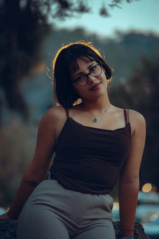 a woman wearing glasses posing for a picture