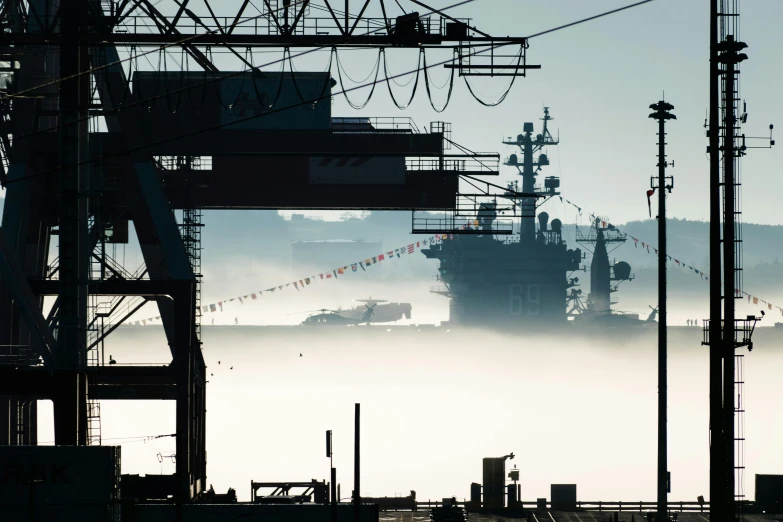 a large ship sitting on the water covered in fog