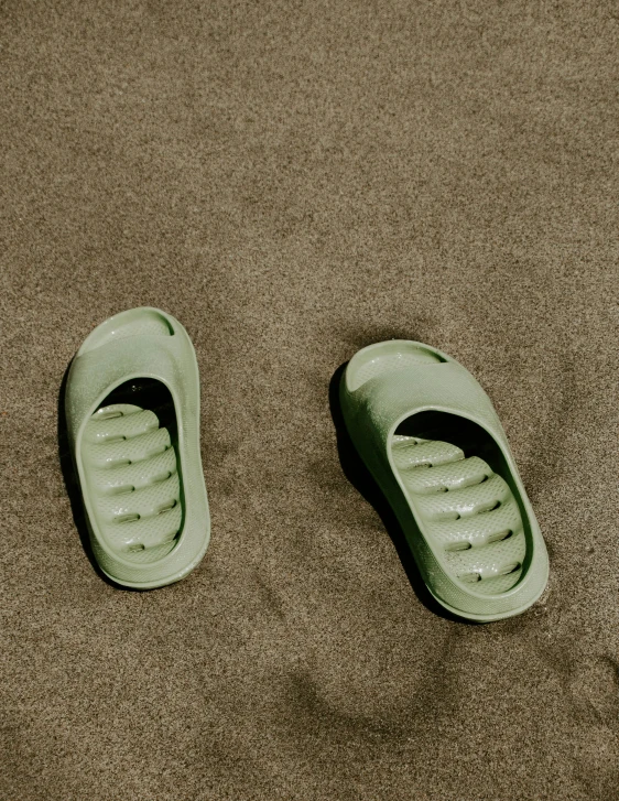 a pair of green shoes resting on the ground