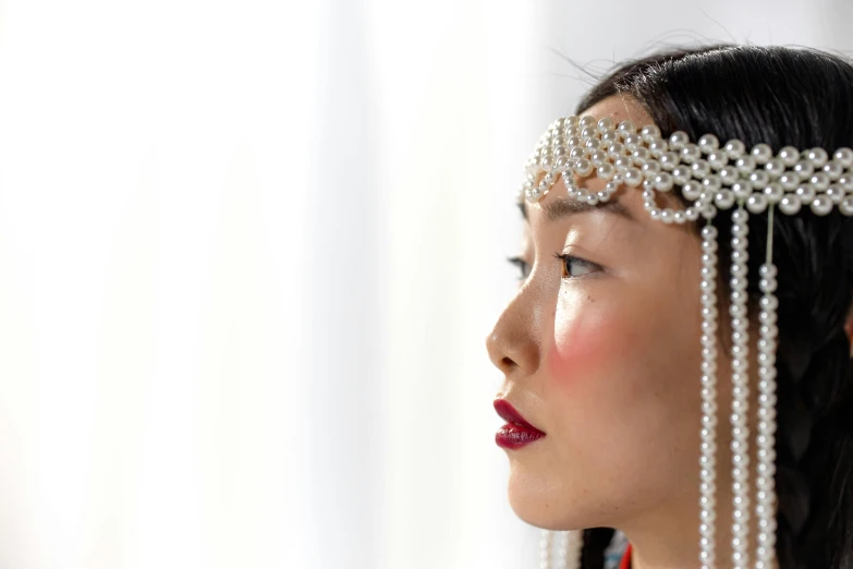 an oriental woman wearing pearls and necklaces