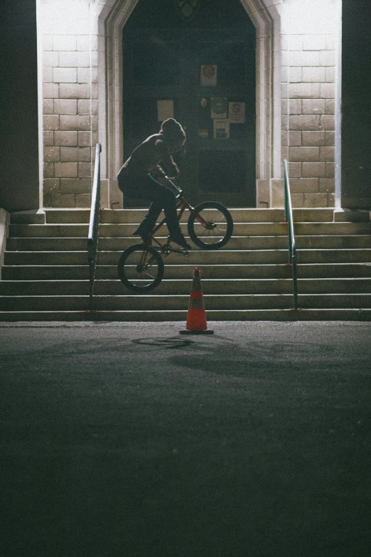 a man is doing tricks on his bike outside of a building