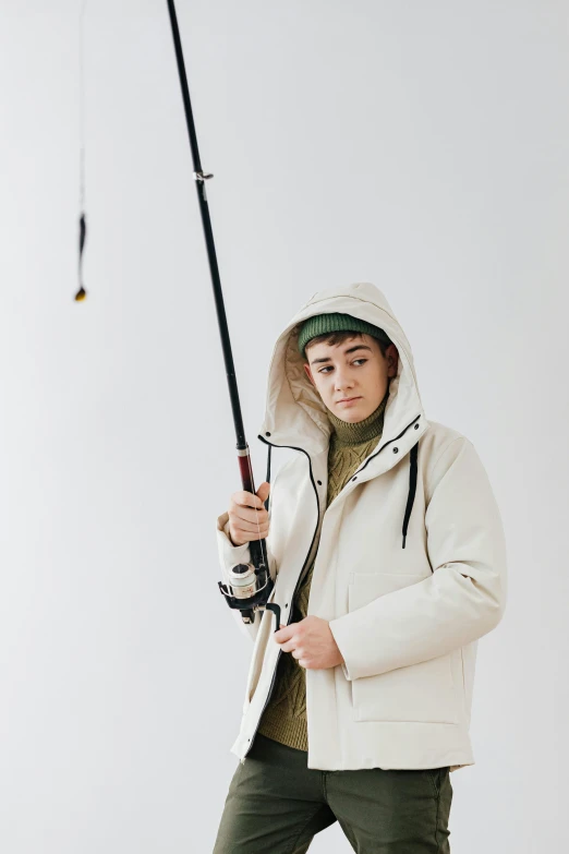 a woman in white jacket holding a fishing pole