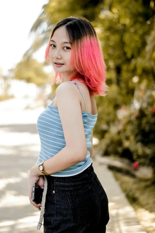 a girl with pink hair is posing for a po