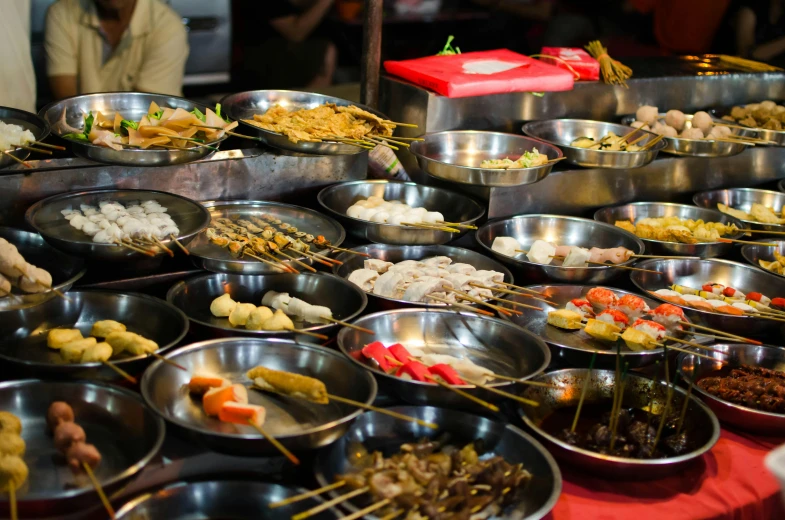 food items displayed in metal pans and serving utensils