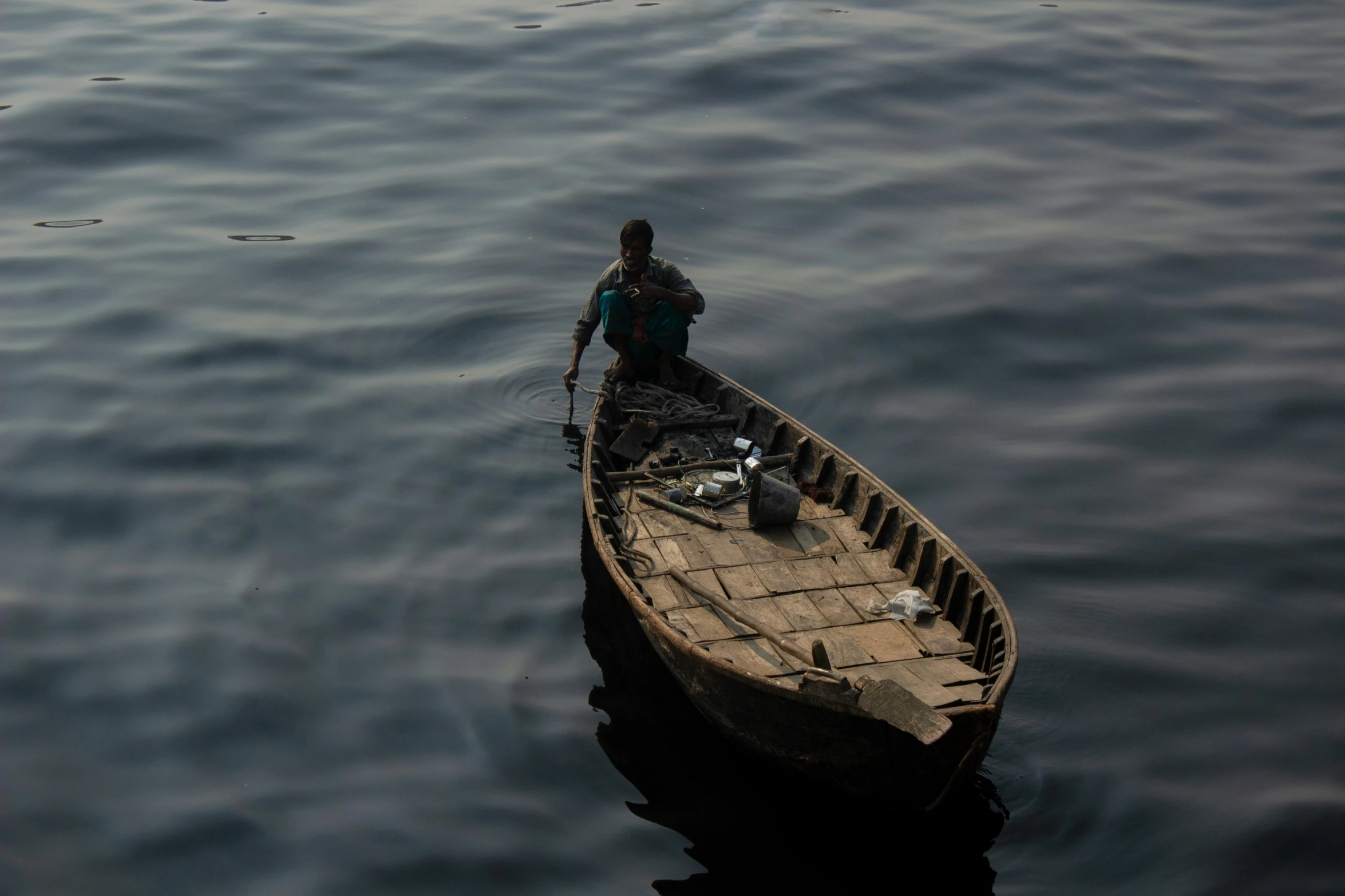 a person stands on the edge of a boat