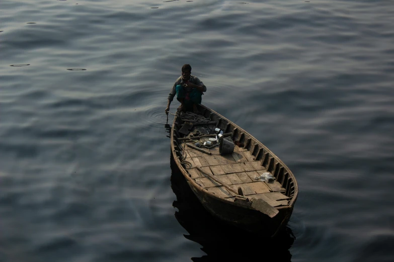 a person stands on the edge of a boat