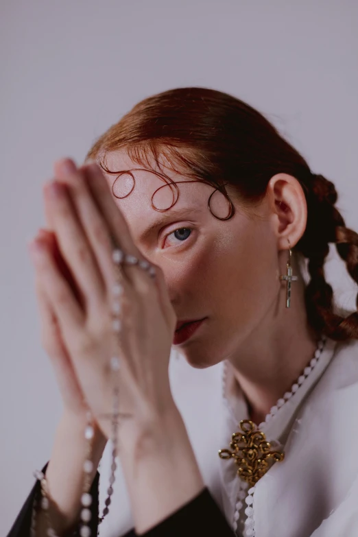 a woman with large round glasses and pearls