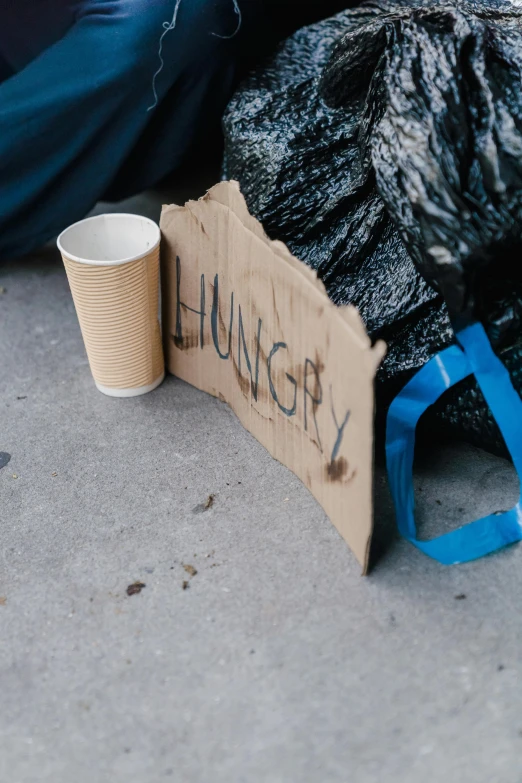 the cup is left on a cardboard sign