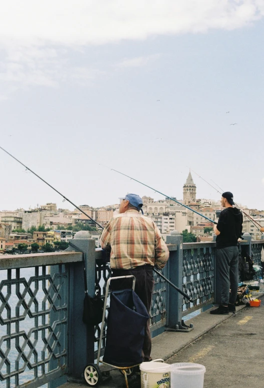 a man who is fishing on a bridge