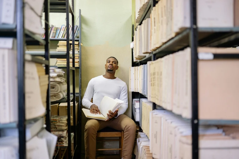 a black man sits in the corner of a liry