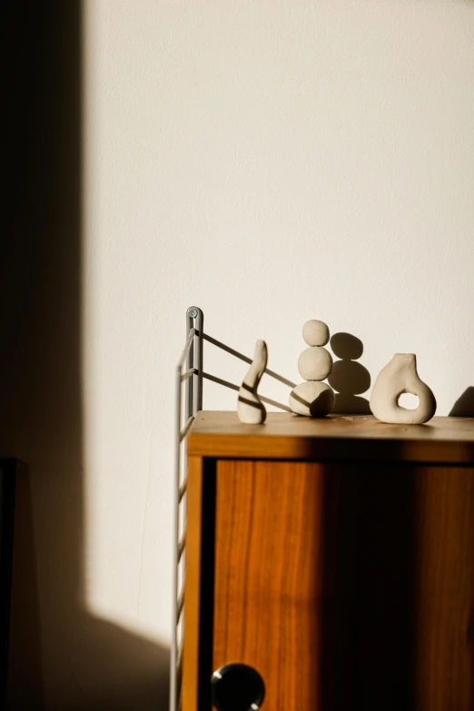 a wooden dresser topped with assorted items and wooden drawer