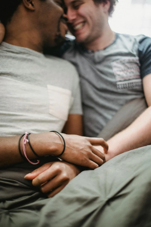 a close up of two people with their arms around each other