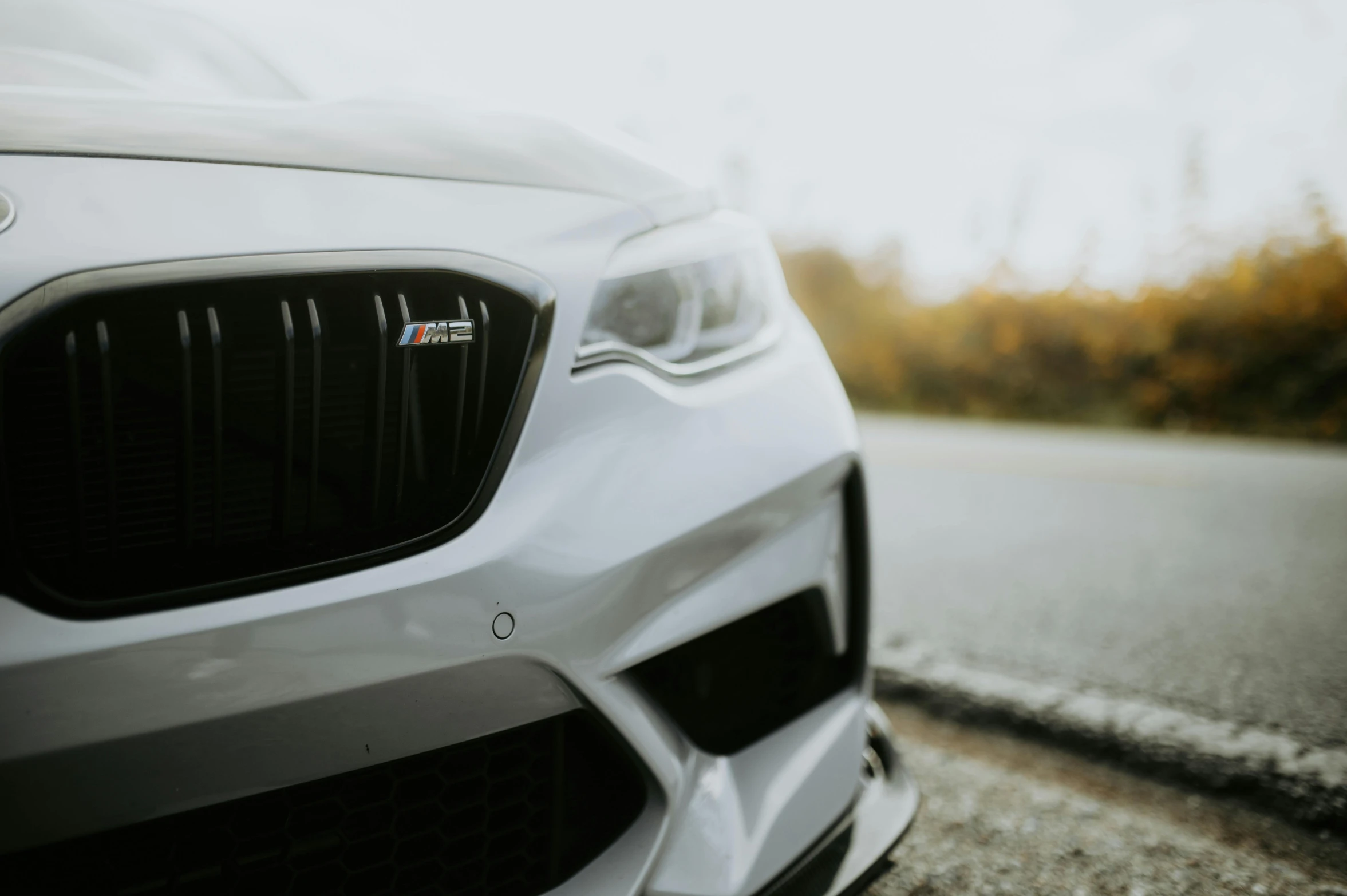 the front of the car with black and white hood on