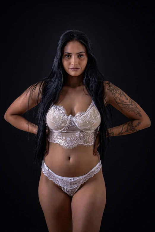 a young black woman is in a white lingerie