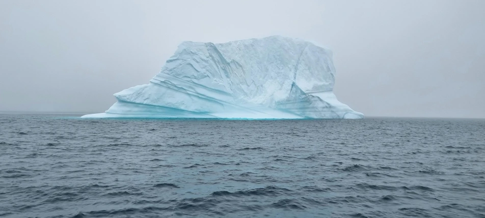 an iceberg is floating over the water