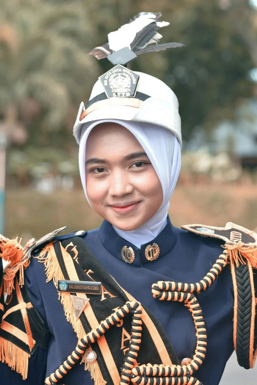 a young woman with an elaborate head piece, in military uniform