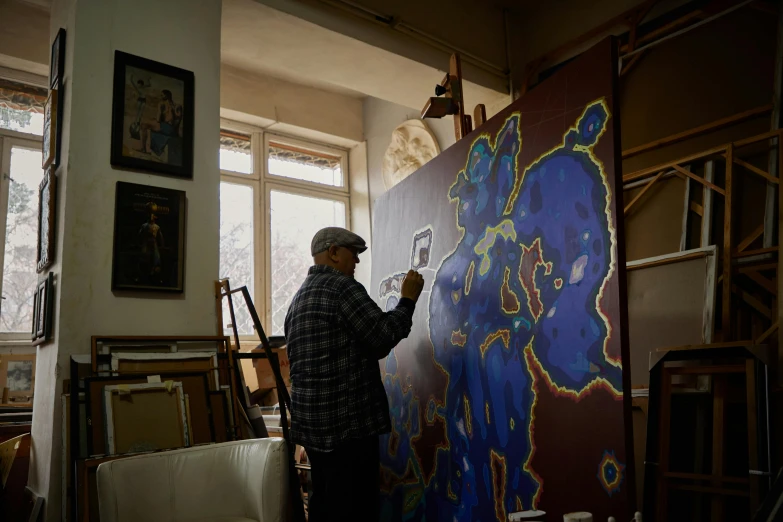 a man painting in the living room of a house