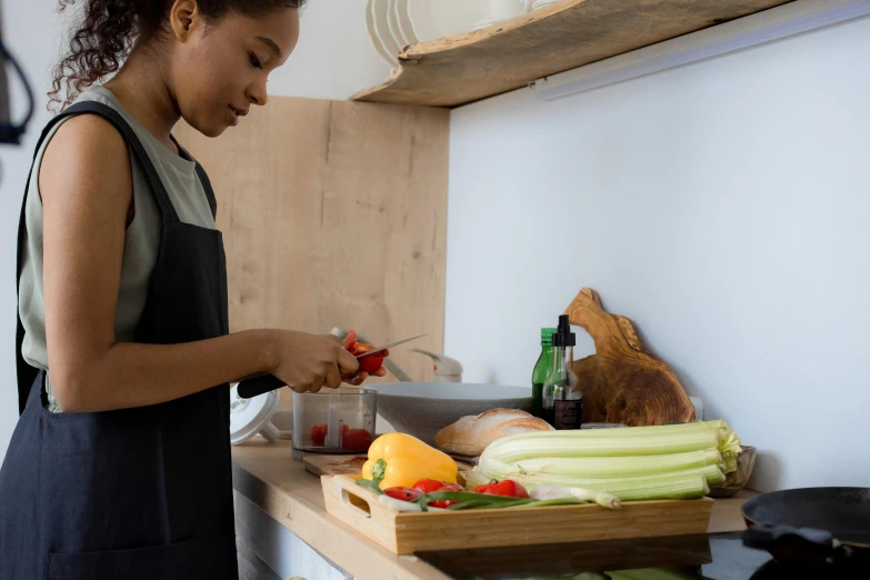 the woman is  up vegetables on the table