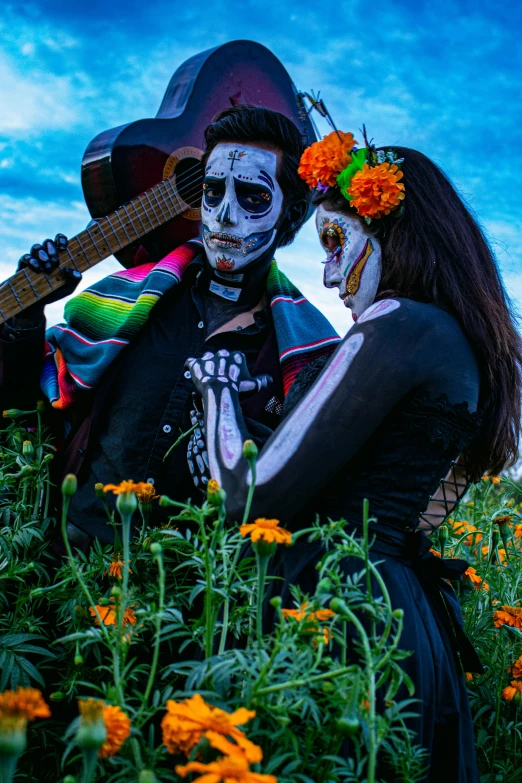 two women are holding guitars and emcing in a field