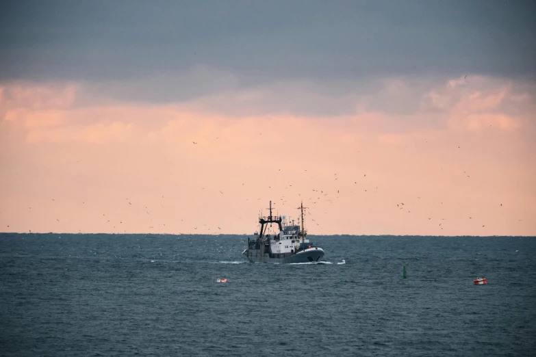 a boat floating in the middle of the ocean