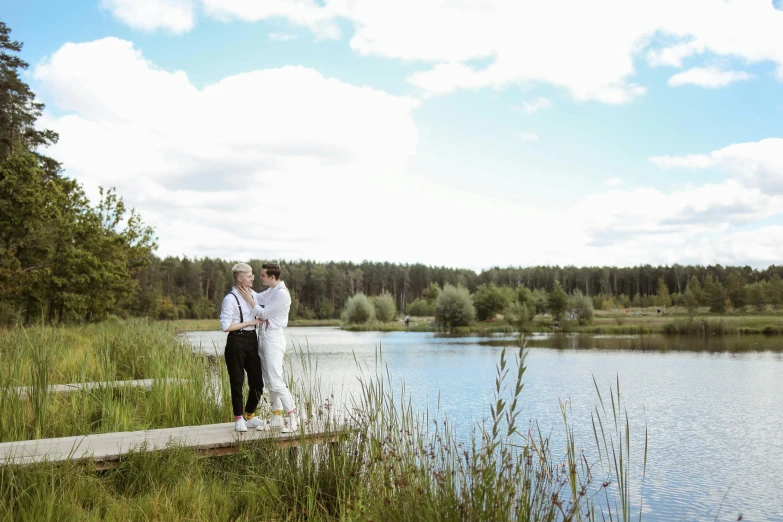 a couple of people standing on top of a dock