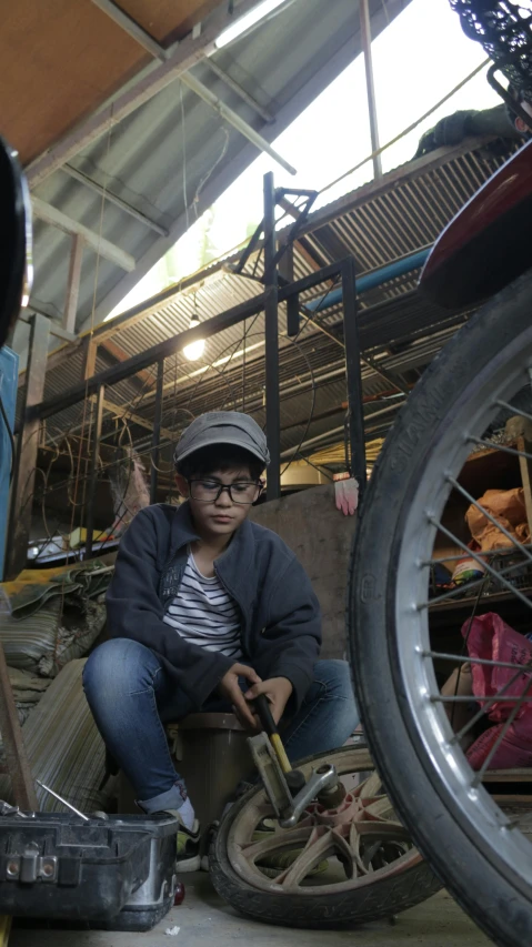 a man is working on a tire in his workshop