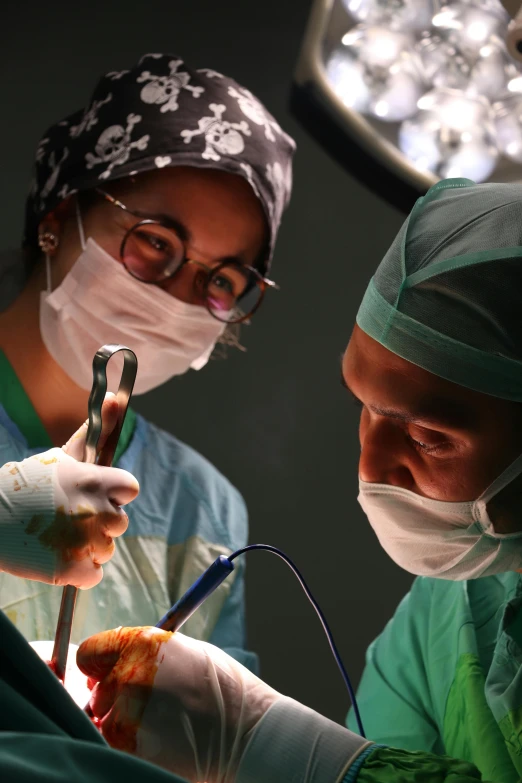 two surgeons looking at the tooth to give them the best view