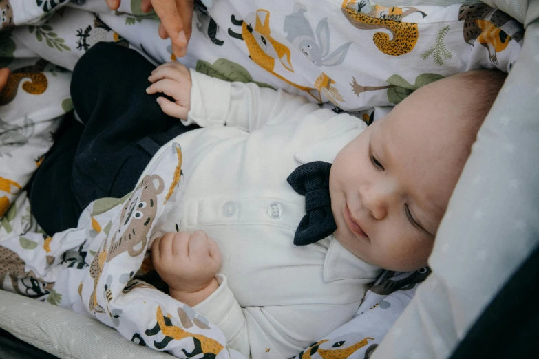 a baby laying down wearing a suit