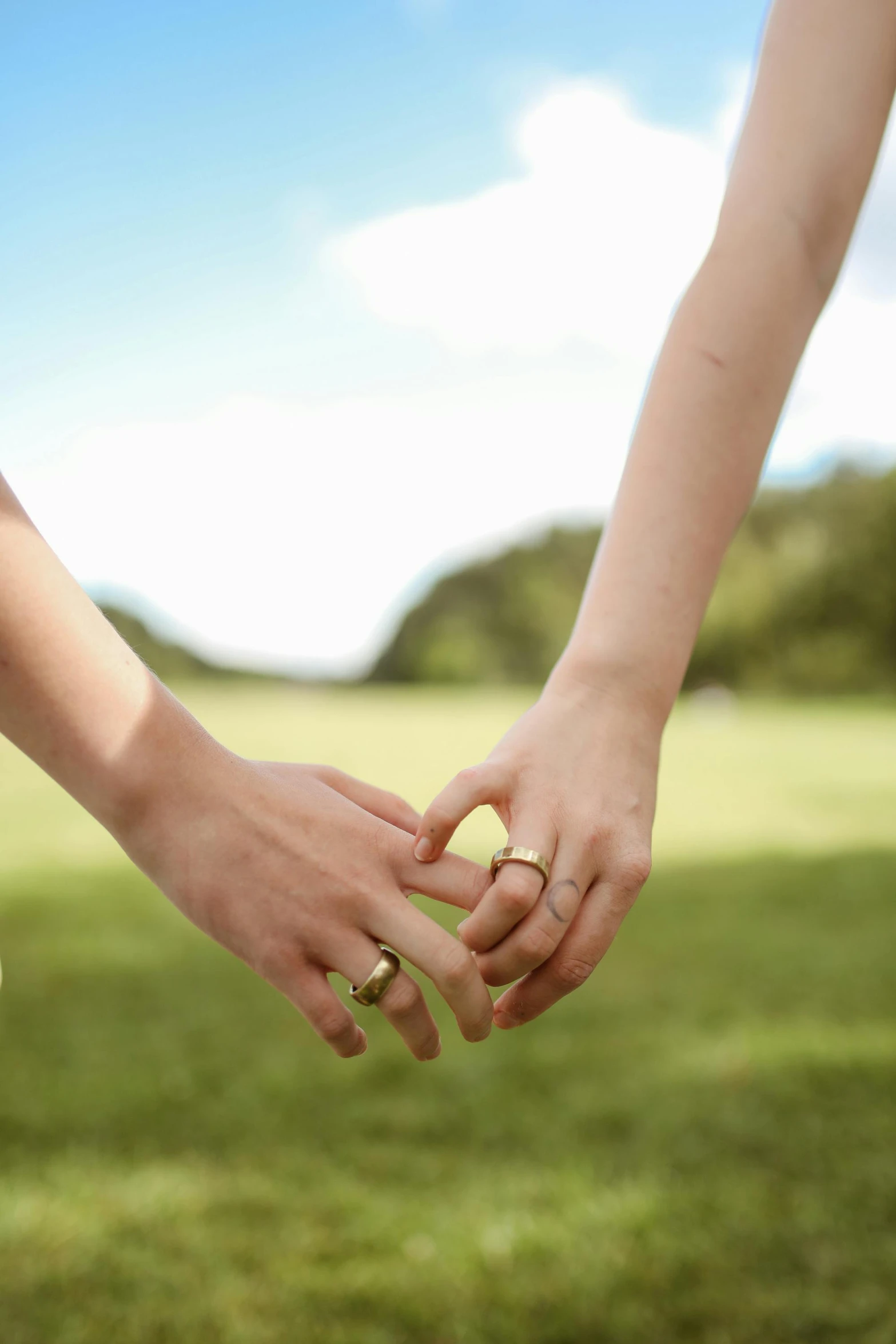 two people holding hands with rings on them