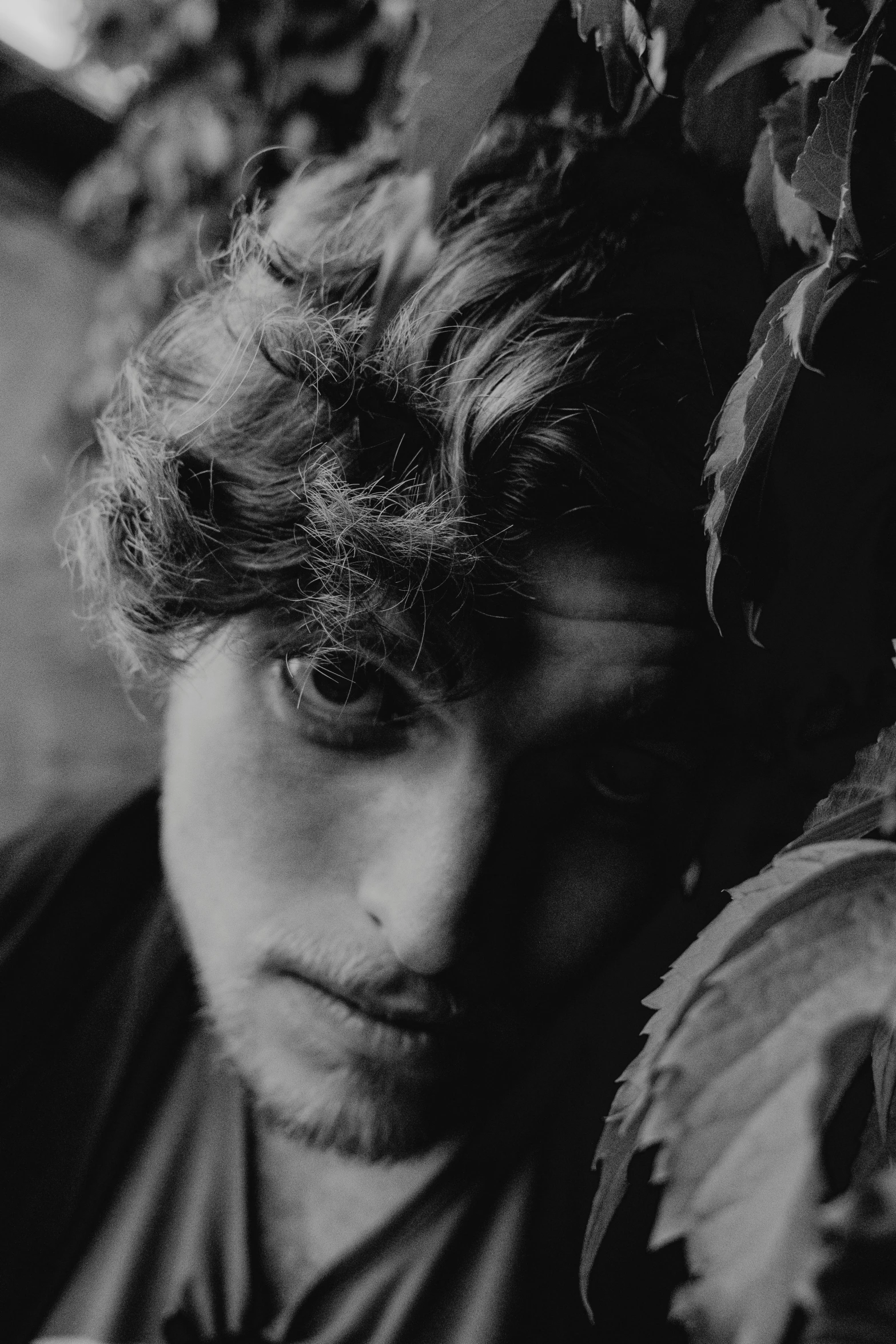 a young man with short hair looking down