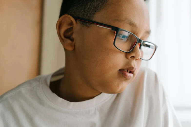 young man with eye glasses looking at soing