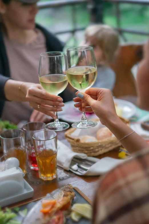 people sitting at a table with wine glasses full