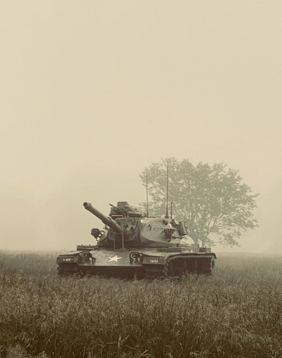 a military tank sits in the middle of a field