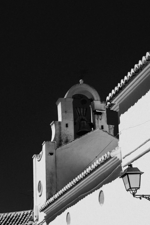 the clock is at the top of the building on the roof