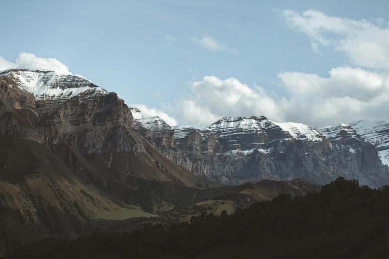 mountains and trees with a light dusting off the snow on them