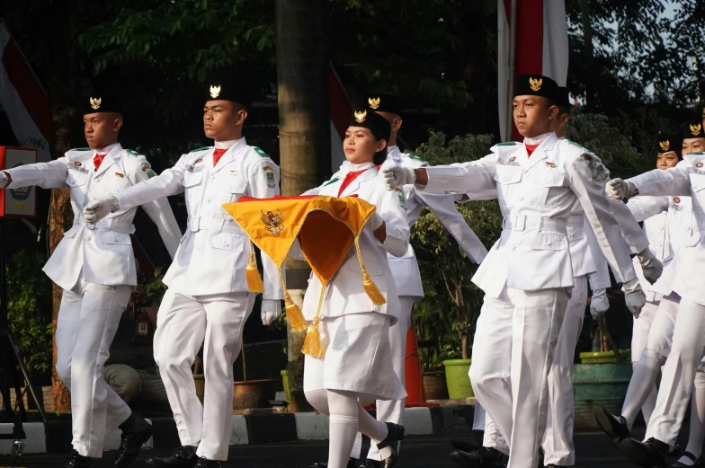 a parade with many people dressed in uniforms