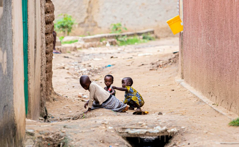 two young men playing around outside in a village