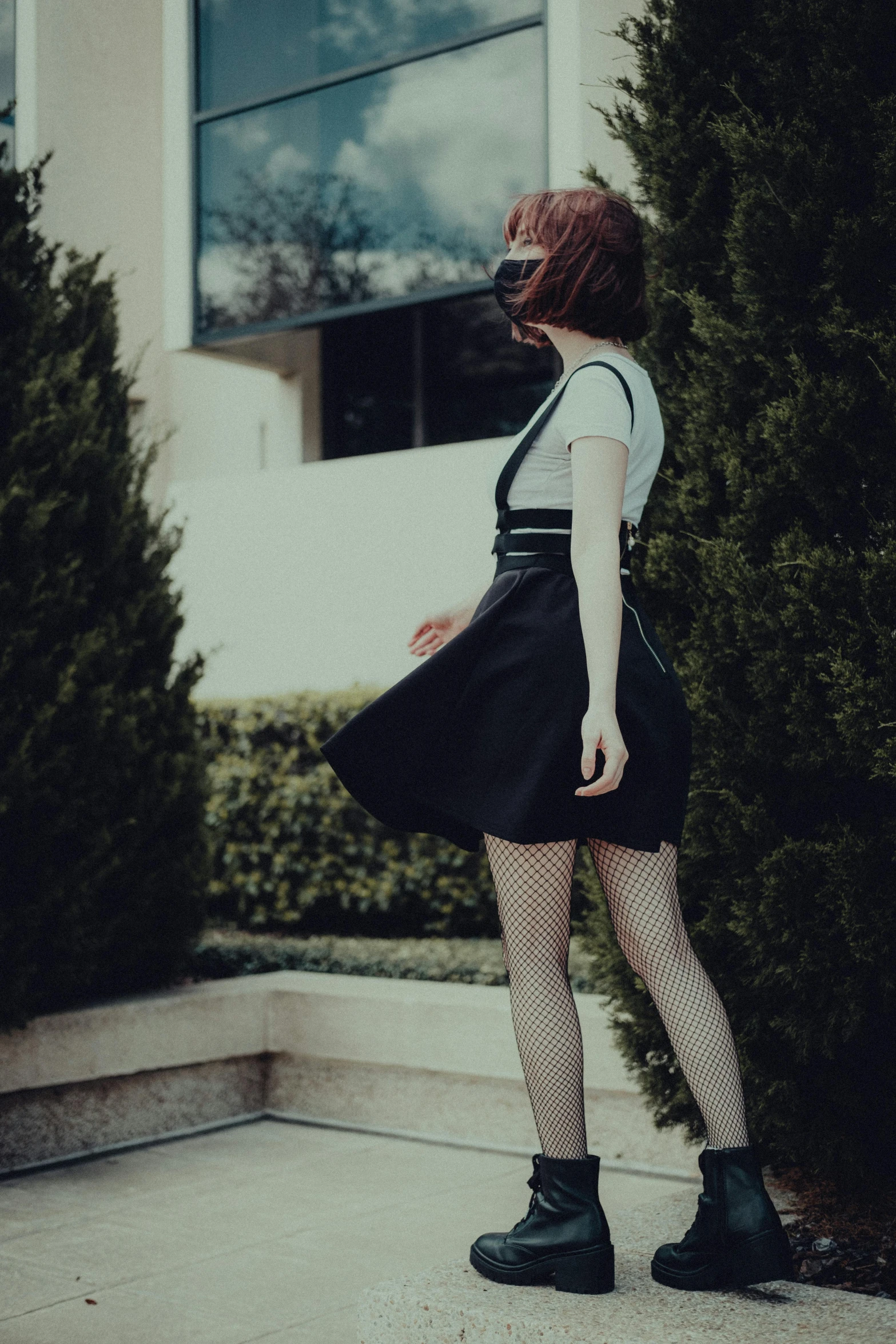 a woman with short legs is posing on a cement ground